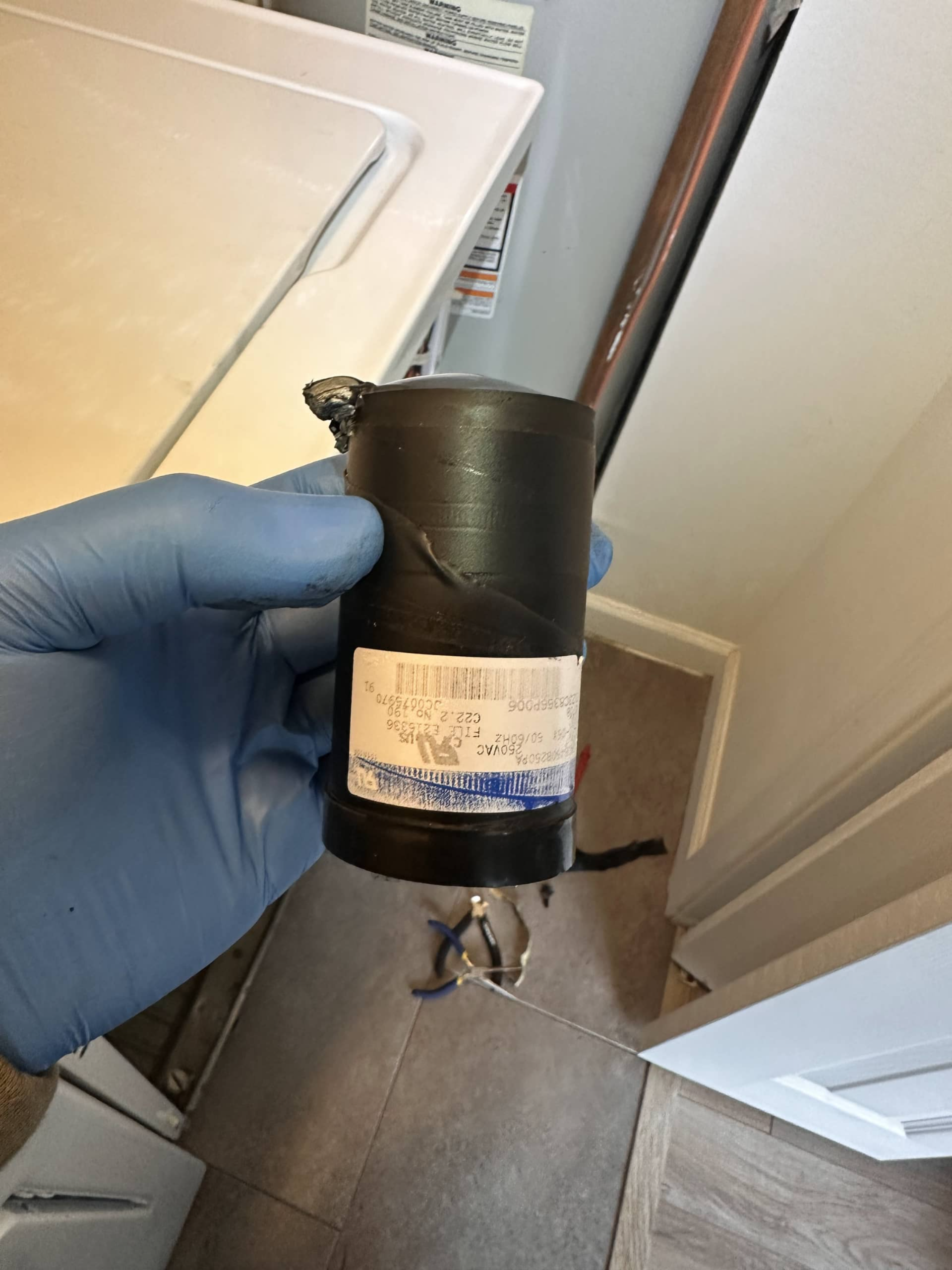 damaged capacitor removed from washer